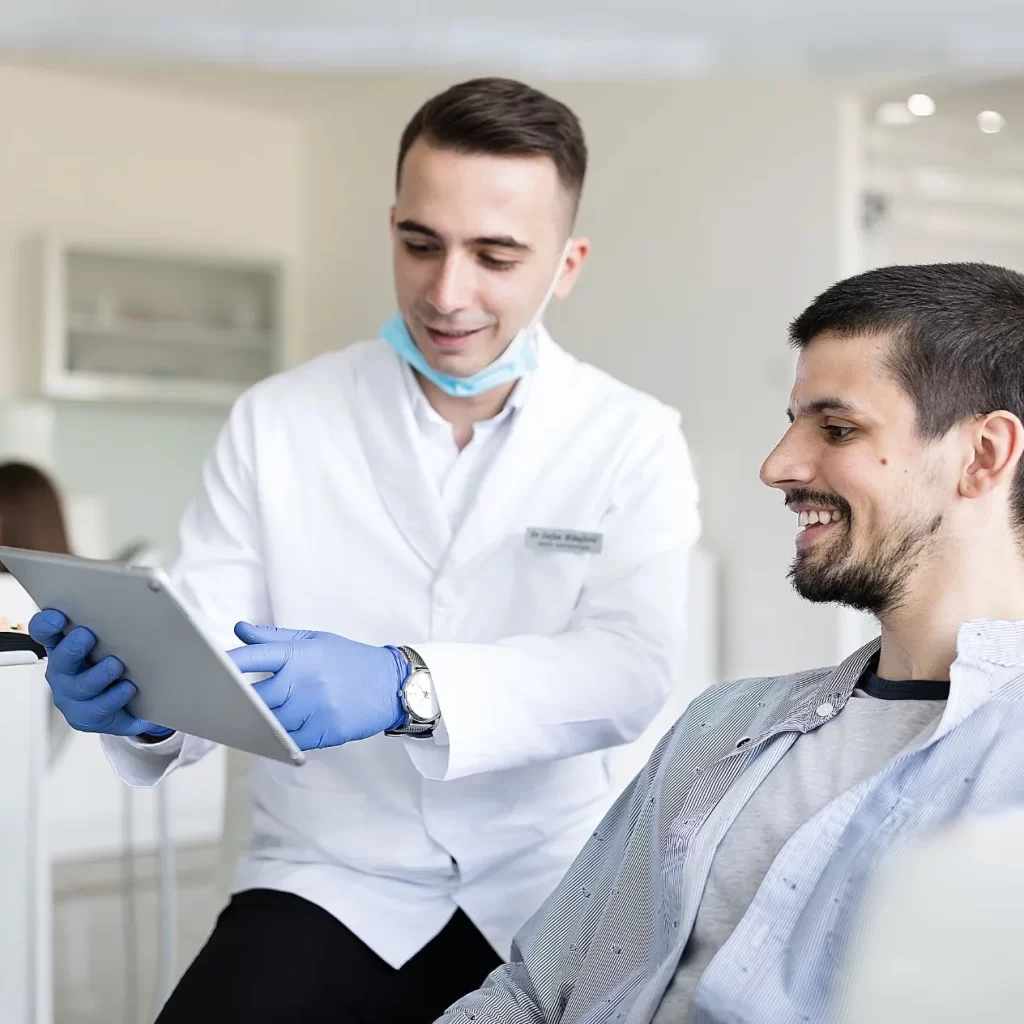 Dentist describing cost of wisdom teeth to patient