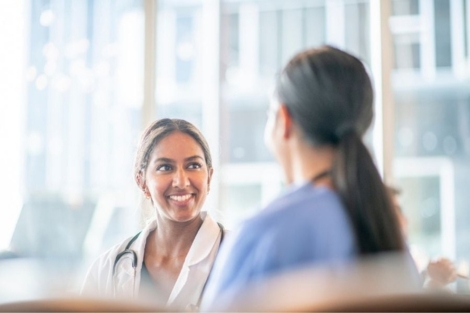 Female family doctor helping women's health patient