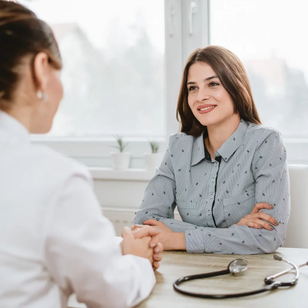 A female patient receiving medical treatment from a doctor with expertise in women's healthcare.