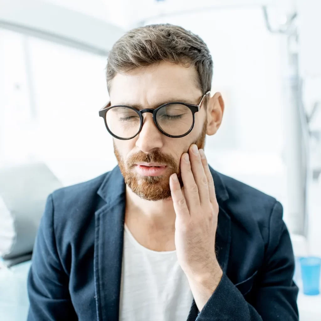 Man in pain from wisdom tooth removal