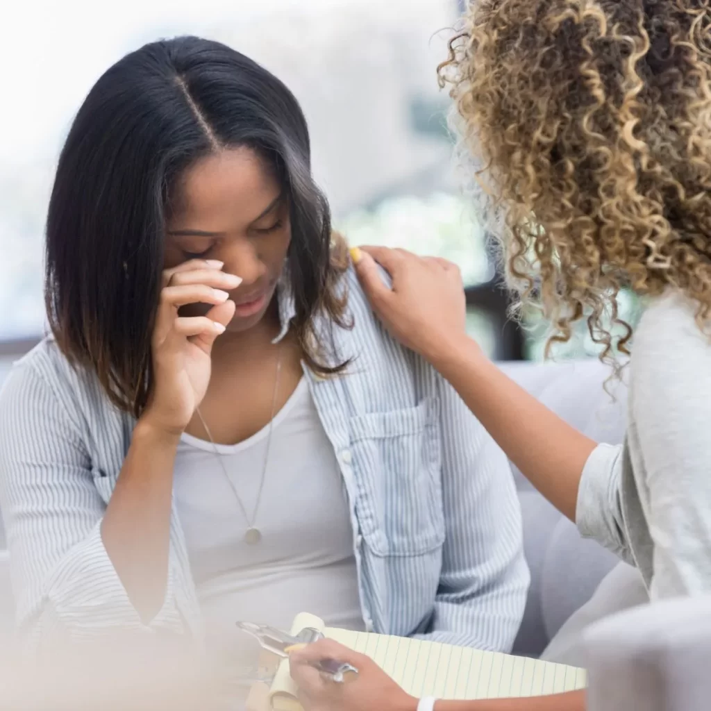 A woman receiving counselling from a mental health professional.