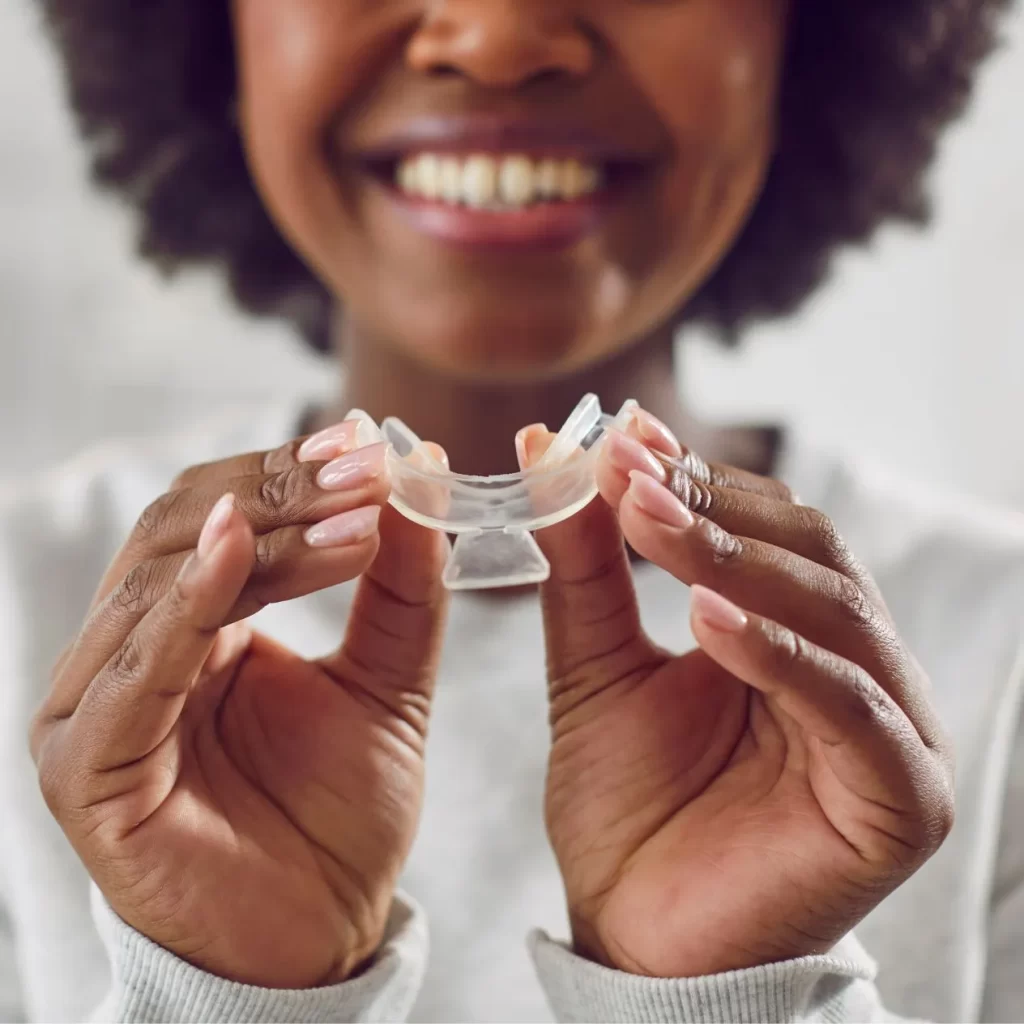 Woman holding custom teeth whitening tray