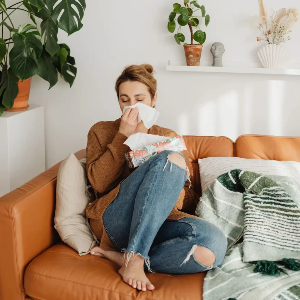 A woman experiencing allergies before visiting an allergist.