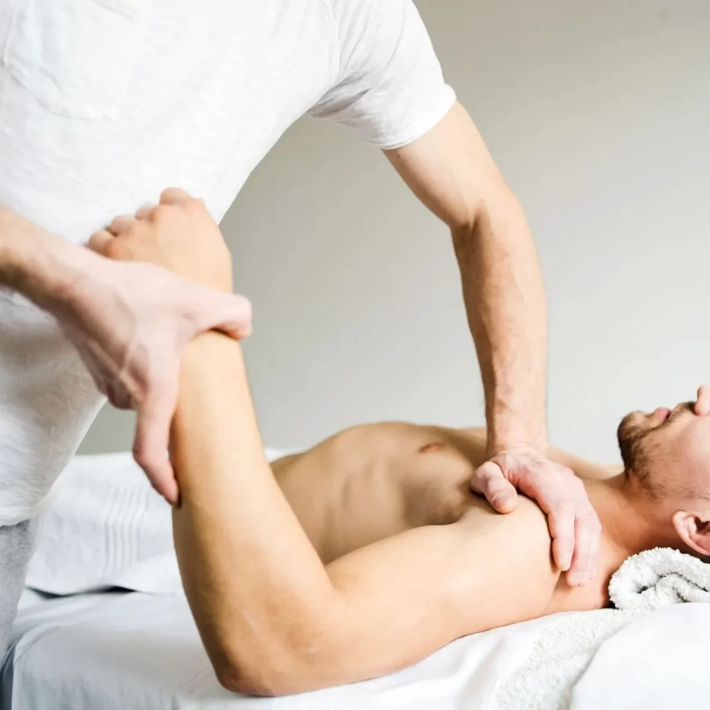 Man doing sports massage on injured shoulder