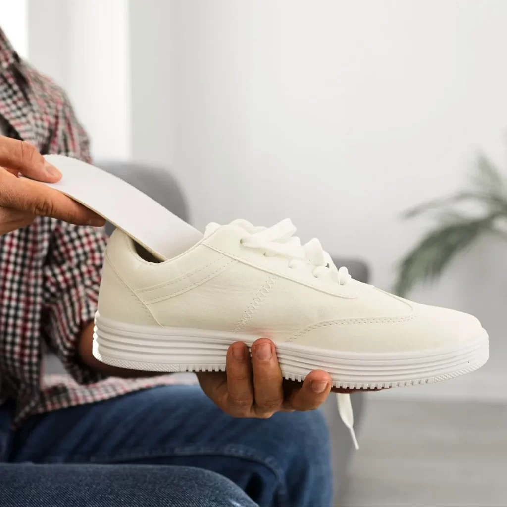 custom orthotic insoles being put in a shoe