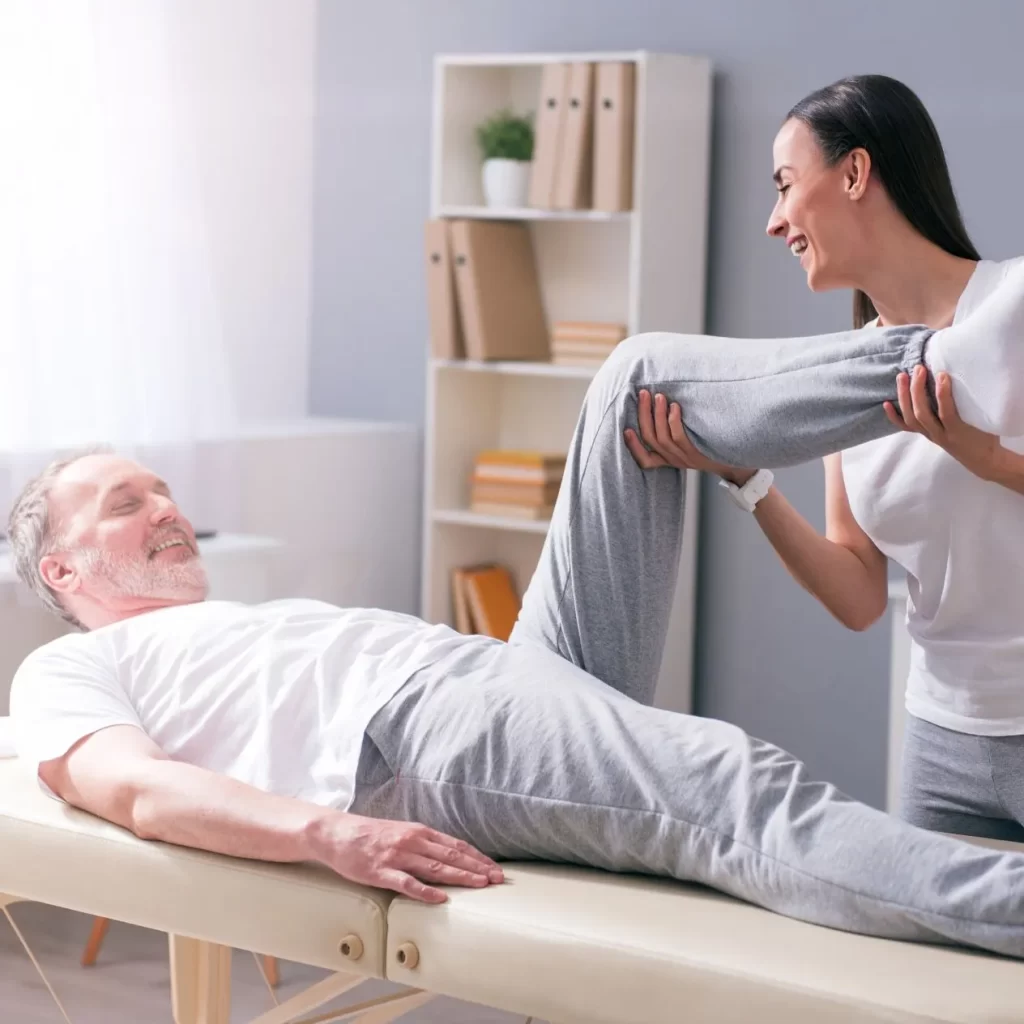 physiotherapist treating a man with knee pain