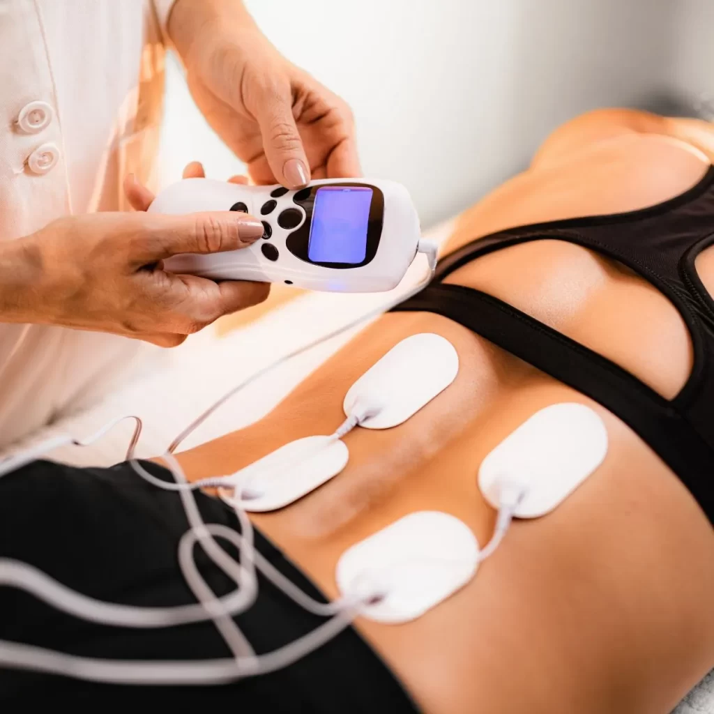 tens machine unit being used on back