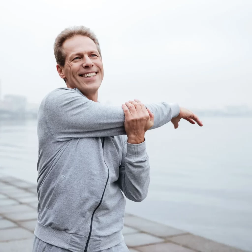 Smiling man stretching living a healthy lifestyle