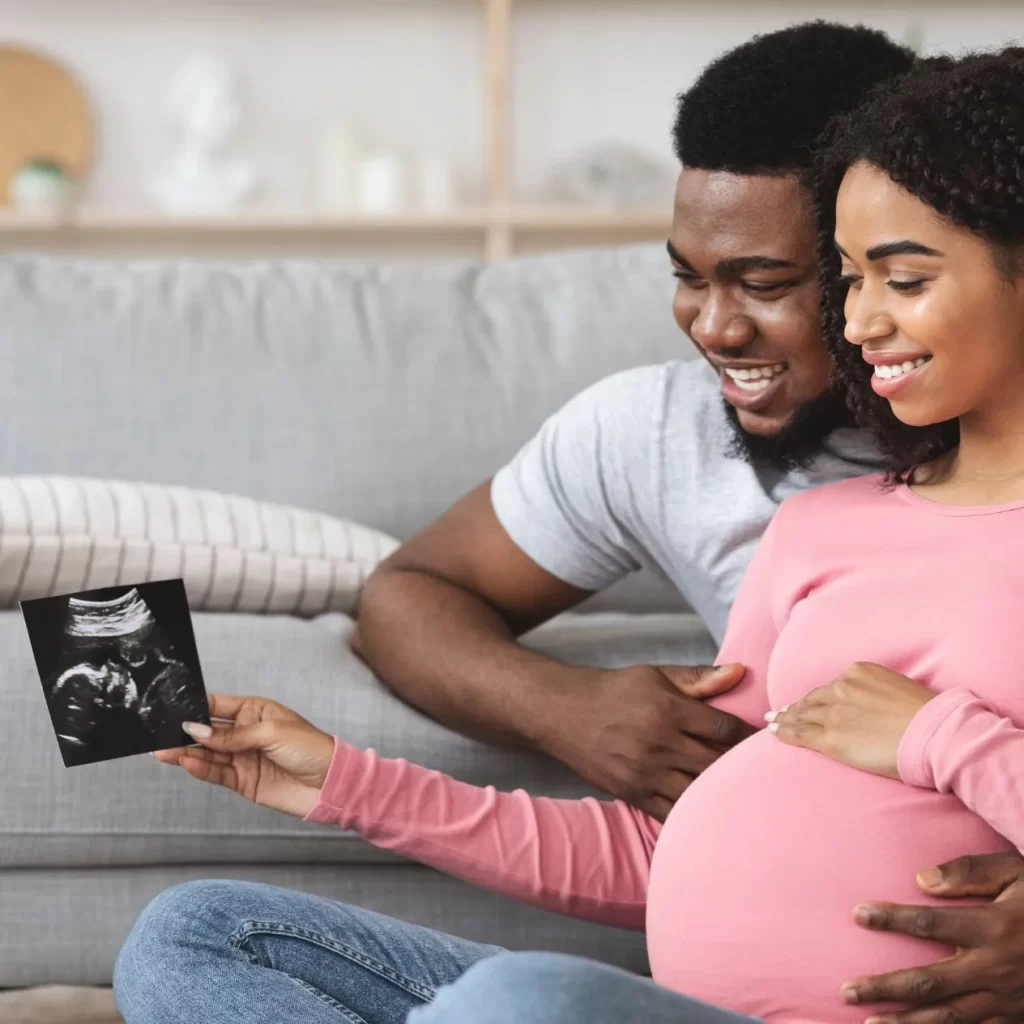 Happy couple looking at prenatal image
