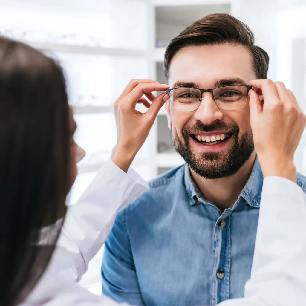 man smiling wearing glasses with blue blocking technology