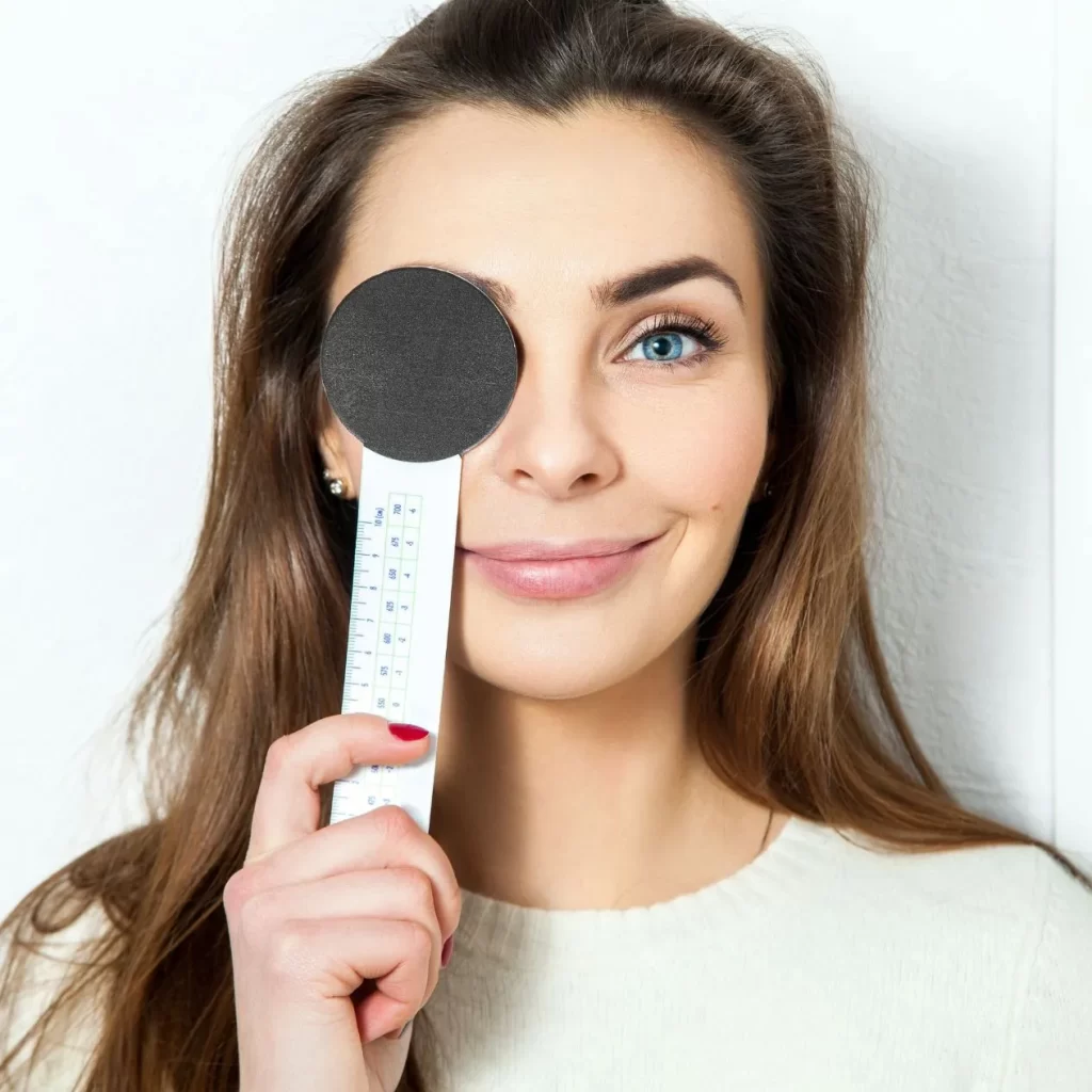 lady holding eye cover during eye examination