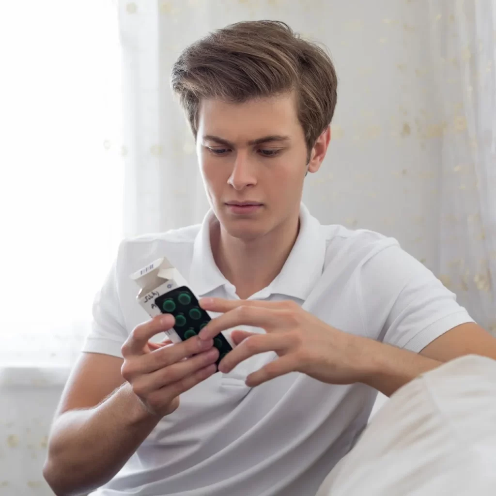 man looking at medication expiry date