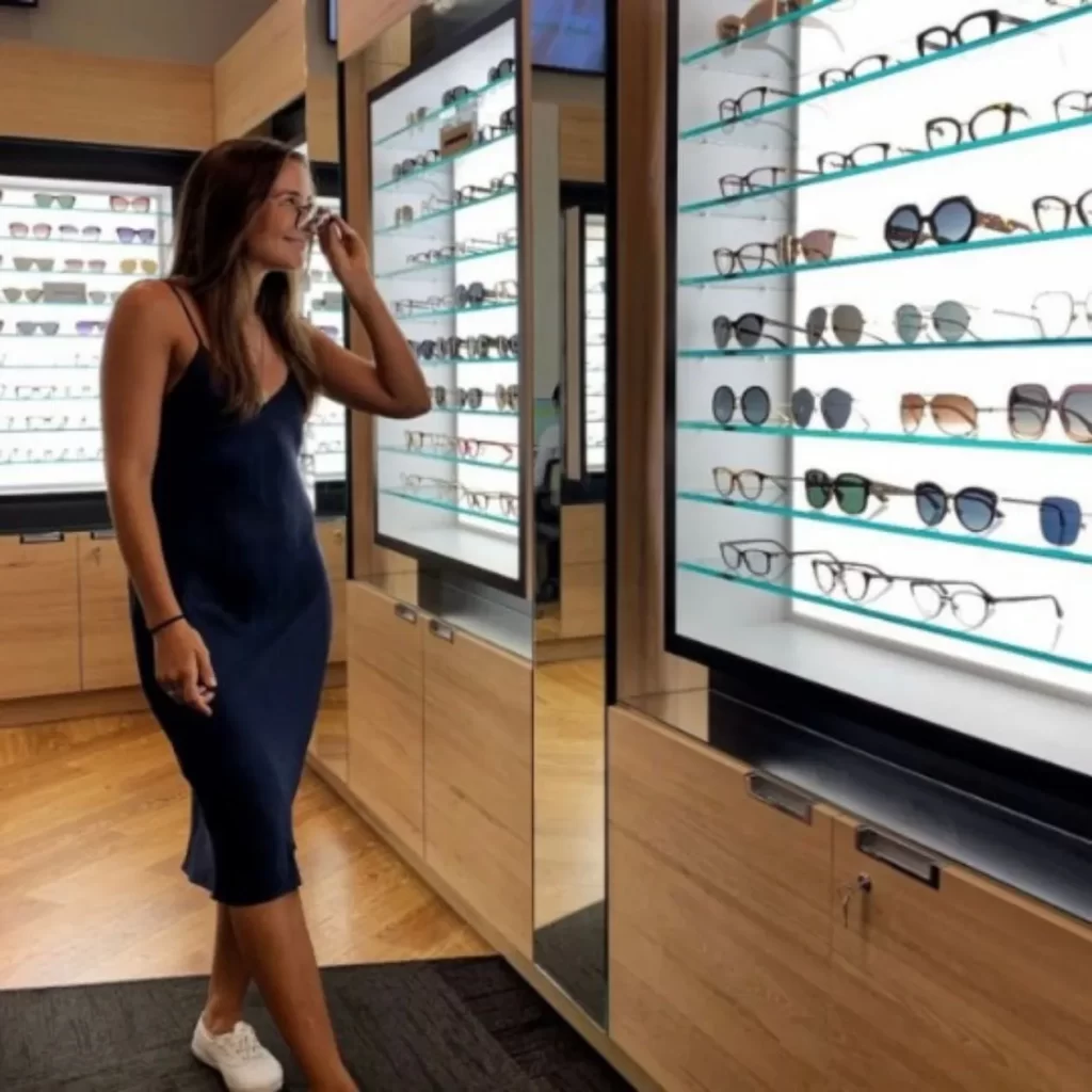 woman trying on prescription glasses in mirror