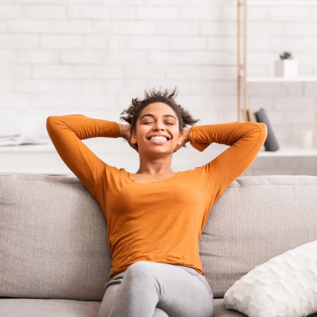happy woman with healthy hormones on a couch