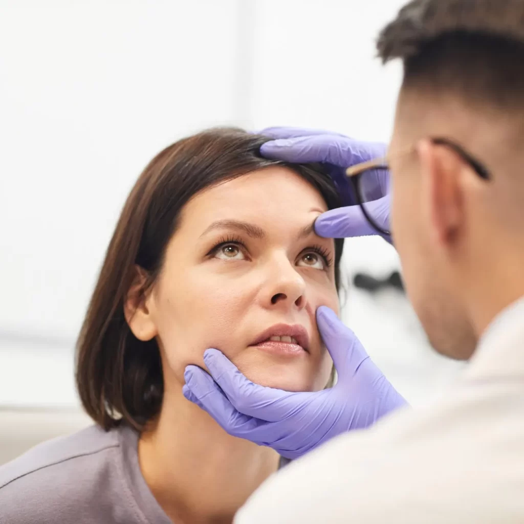 optometrist assessing a woman with an eye injury