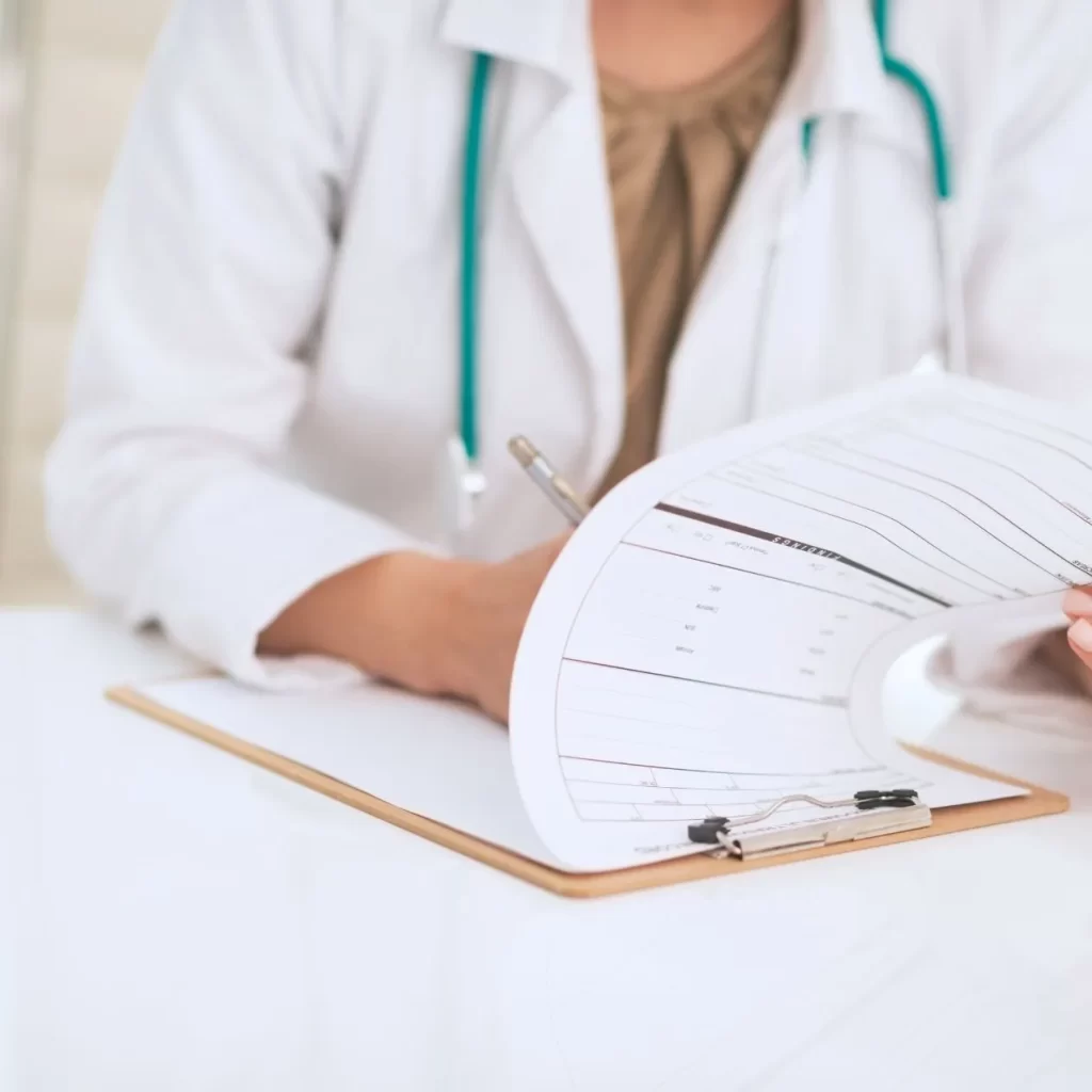 Doctor writing a medical note with a referral