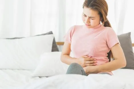 Bloated woman holding her stomach from pain
