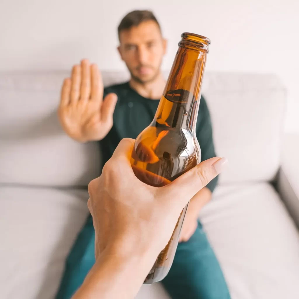 man refusing alcohol from addiction