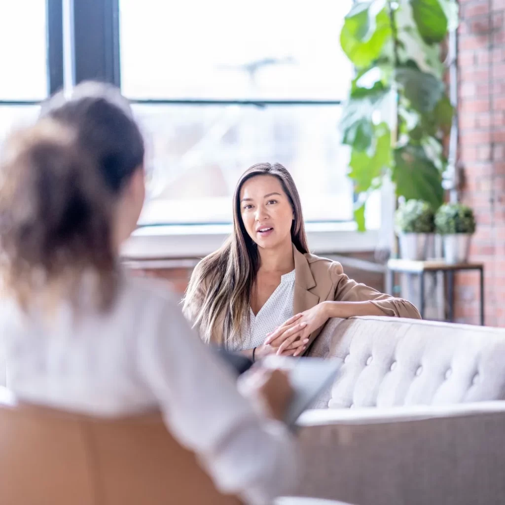 woman speaking with a therapist during meet and greet