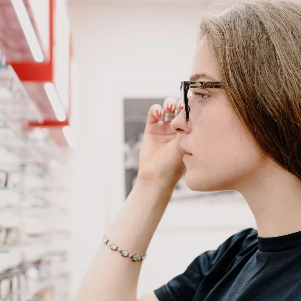 woman trying on custom prescription glasses