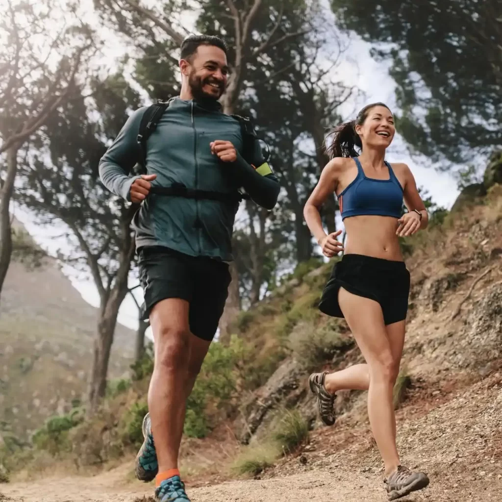Two people running outdoors to improve physical health