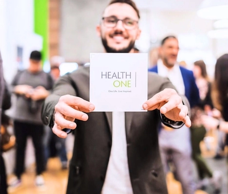 patient happy with healthone services holding brochure