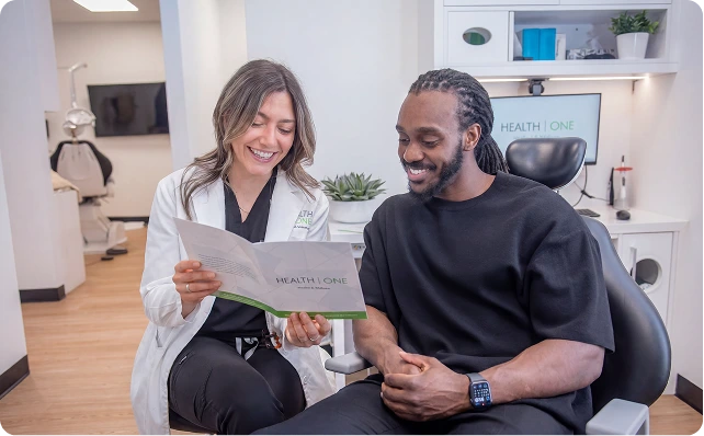 best dentist showing brochure to anxious patient toronto